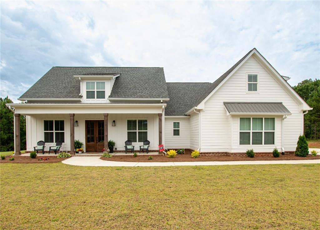 2841 Ike Stone Road Monroe, GA 30656 - Photo 1 of 1 a view of a white building with couches and swimming pool with a barbeque grill