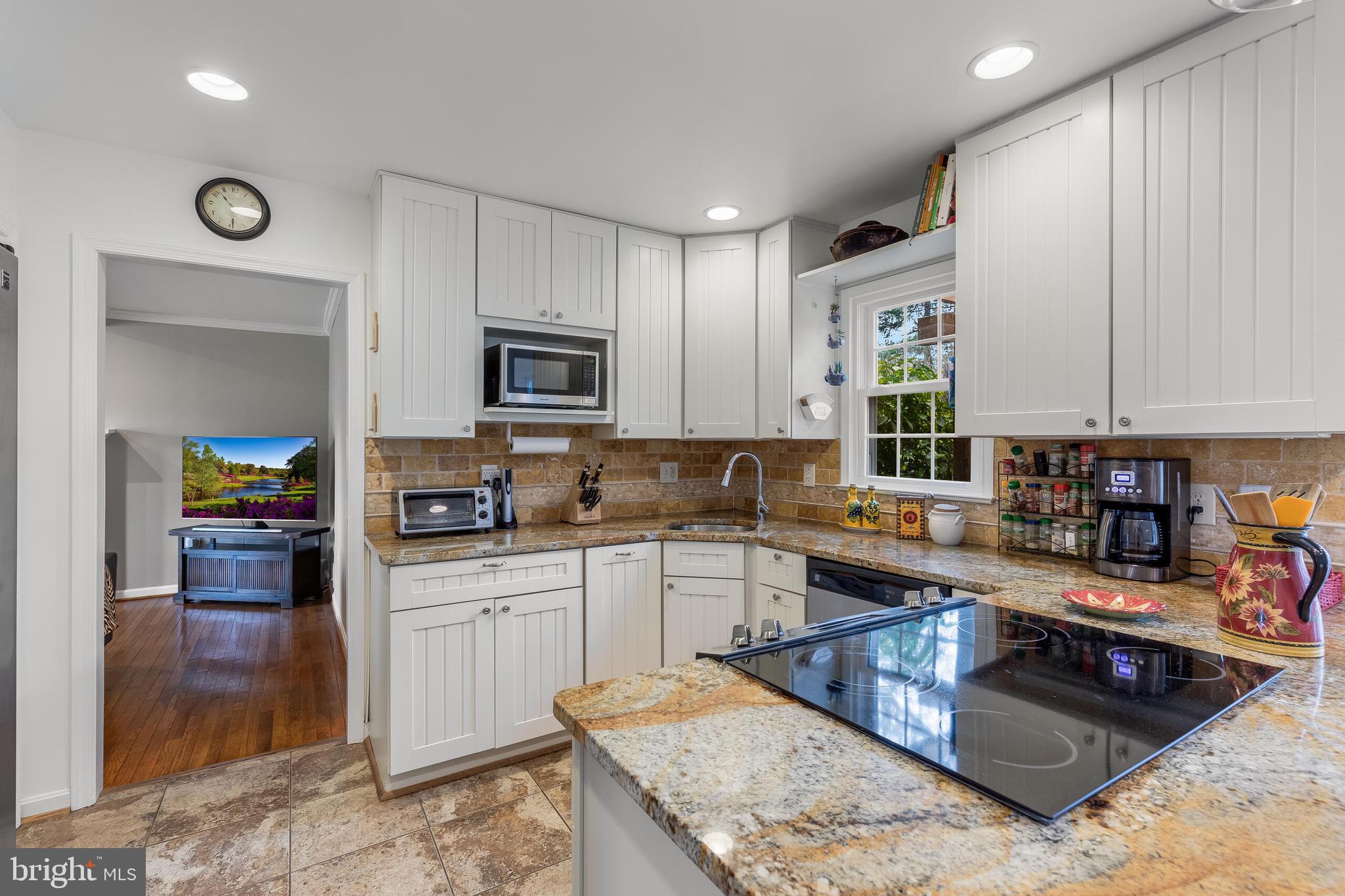 1700 Chester Mill Road Silver Spring, MD 20906 - Photo 14 of 53 a kitchen with stainless steel appliances granite countertop a stove top oven a sink a counter space and cabinets