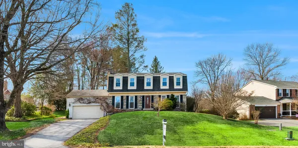 a aerial view of a house next to a big yard and large trees