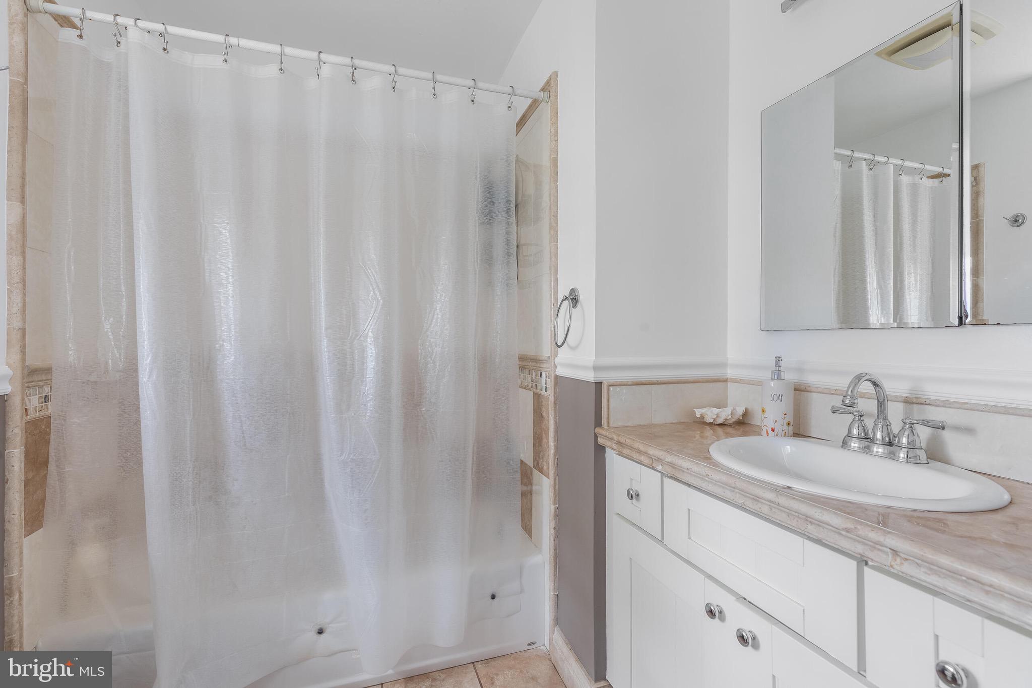 1700 Chester Mill Road Silver Spring, MD 20906 - Photo 22 of 53 a bathroom with a sink and a mirror
