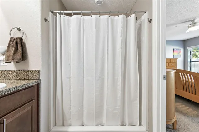 a view of walk in closet with clothes