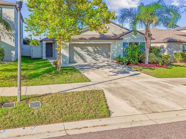 an aerial view of residential houses with outdoor space and street view