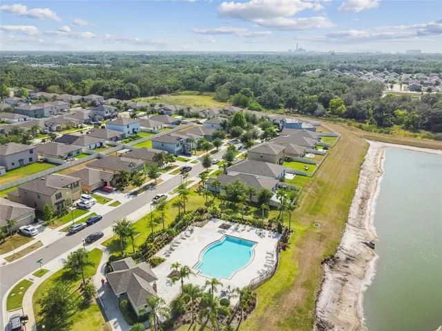 an aerial view of residential houses with outdoor space and swimming pool