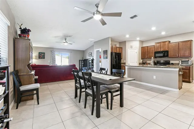 a view of a dining room with furniture and chandelier