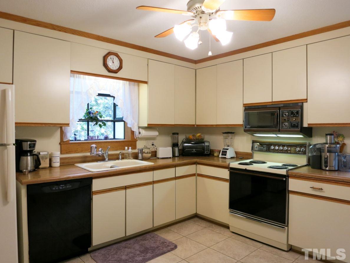 613 Compton Road Raleigh, NC 27609 - Photo 8 of 25 a kitchen with a sink a stove and microwave