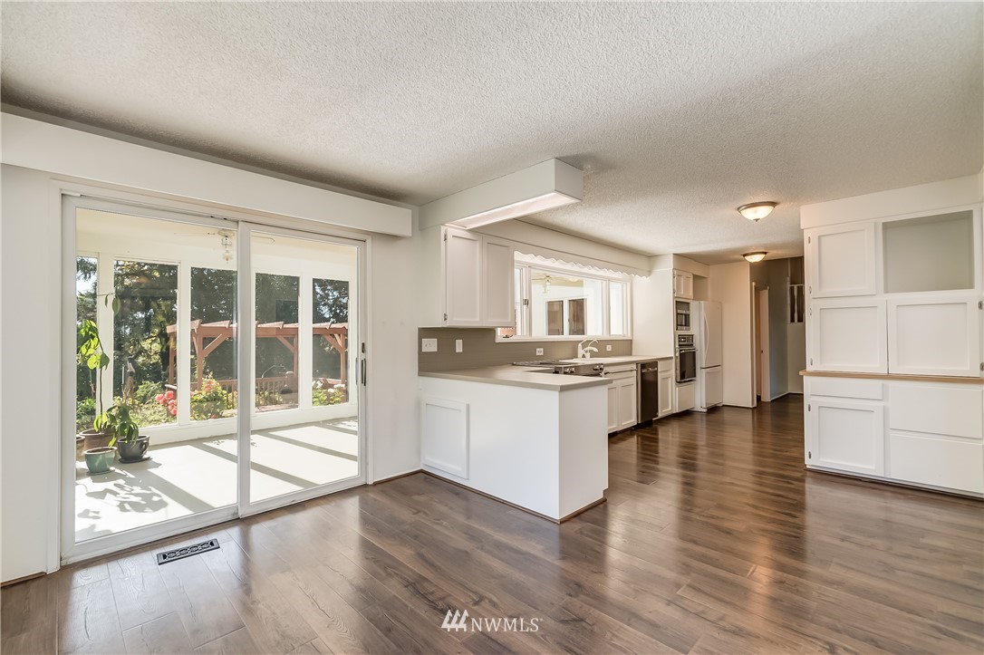 3367 Clearbrook Road Sumas, WA 98295 - Photo 11 of 25 a kitchen with a refrigerator and wooden floor