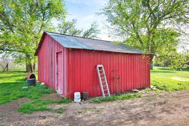 a view of barn with wooden fence