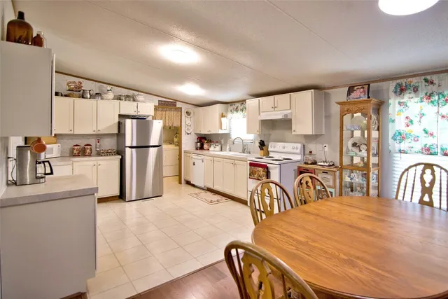 a bathroom with a sink double vanity granite tub shower and a mirror