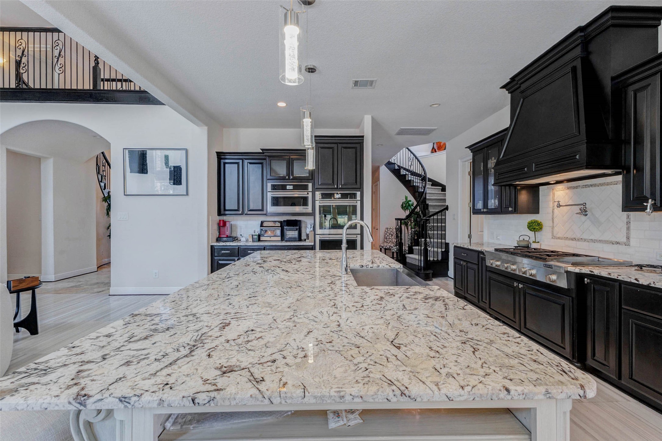 2310 Legends Way Katy, TX 77493 - Photo 12 of 50 a kitchen with stainless steel appliances kitchen island granite countertop a stove and a refrigerator