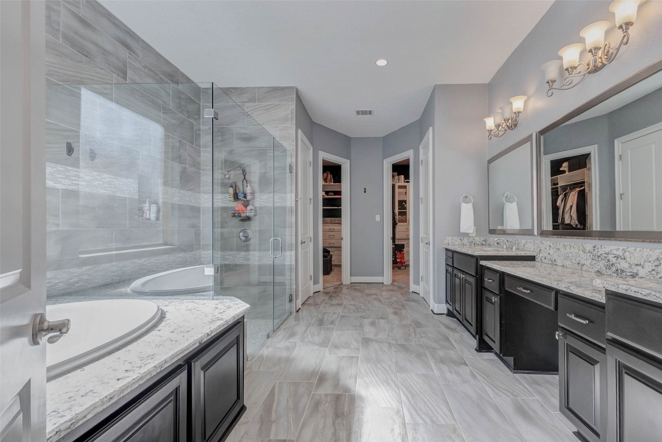 2310 Legends Way Katy, TX 77493 - Photo 20 of 50 a bathroom with a granite countertop sink a toilet a large mirror and shower