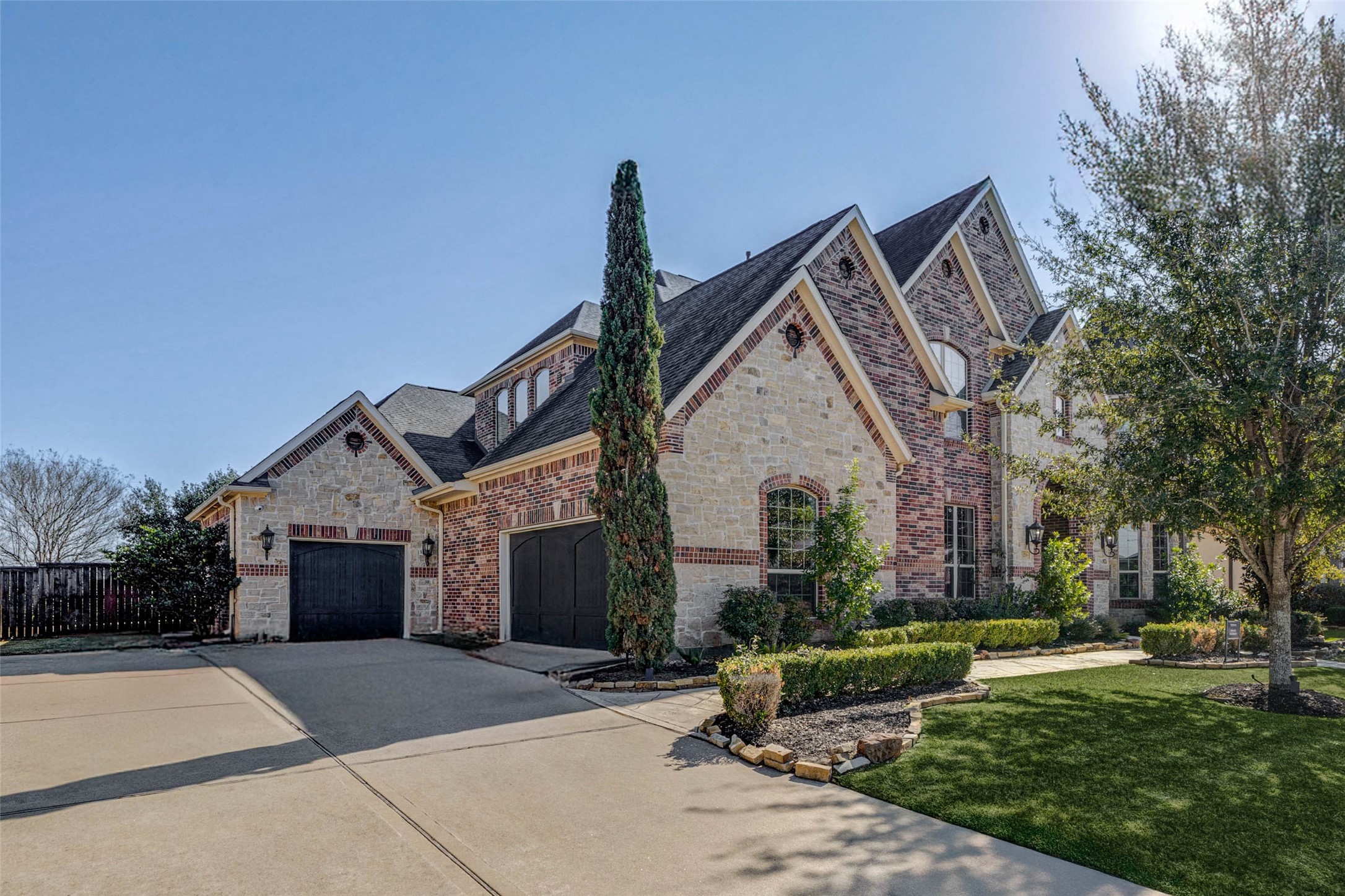 2310 Legends Way Katy, TX 77493 - Photo 4 of 50 a front view of a house with a garden and trees