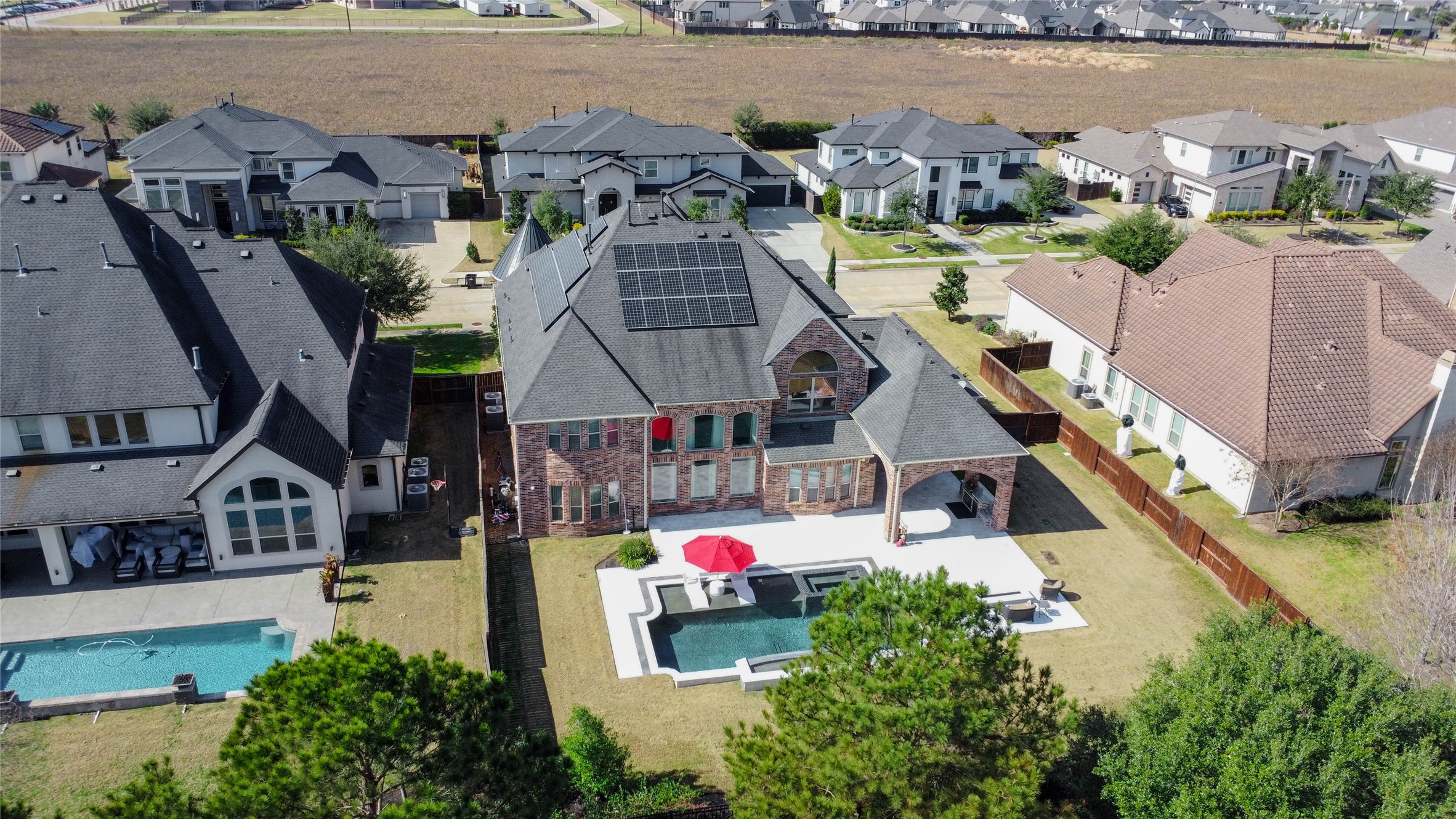 2310 Legends Way Katy, TX 77493 - Photo 41 of 50 an aerial view of a house with swimming pool and lake view