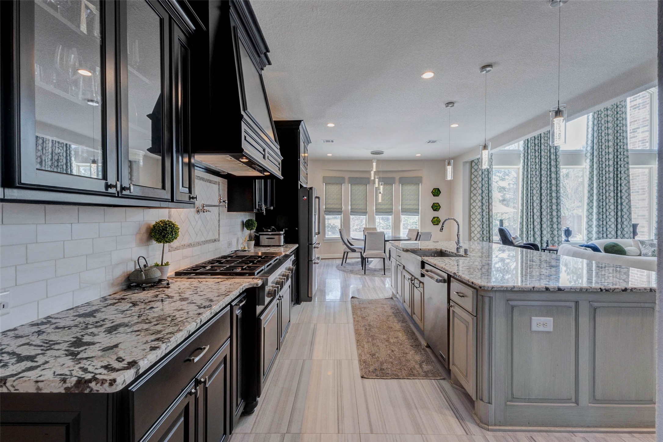 2310 Legends Way Katy, TX 77493 - Photo 10 of 50 a kitchen with stainless steel appliances granite countertop a stove top oven a sink dishwasher and cabinets with wooden floor