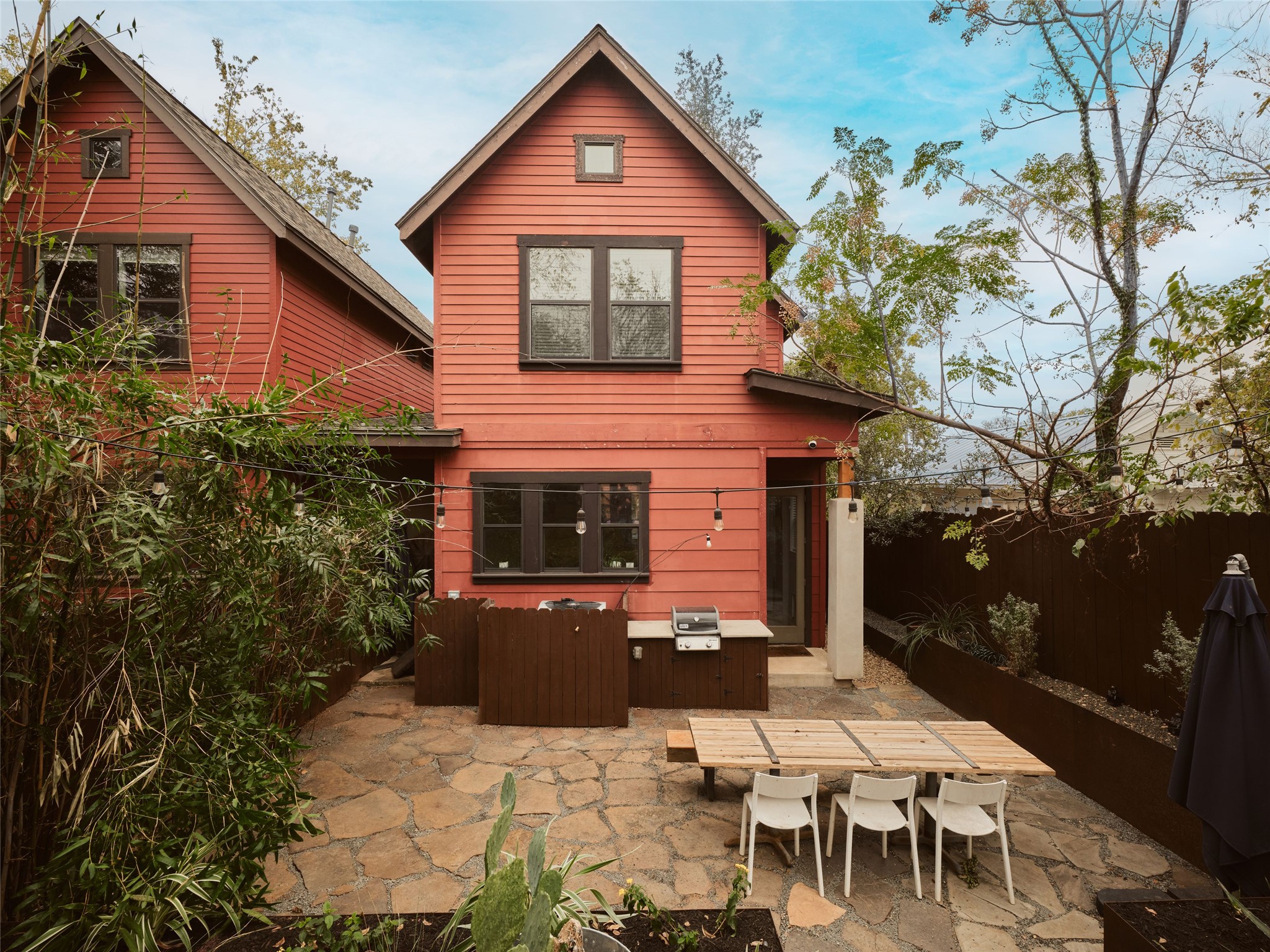 2002 East 13th Street, Unit A Austin, TX 78702 - Photo 2 of 37 Back of property with a patio and outdoor dining area