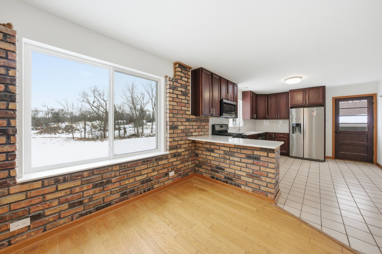 21122 Hillside Road Frankfort, IL 60423 - Photo 14 of 48 a large kitchen with kitchen island granite countertop a large window and a counter top space
