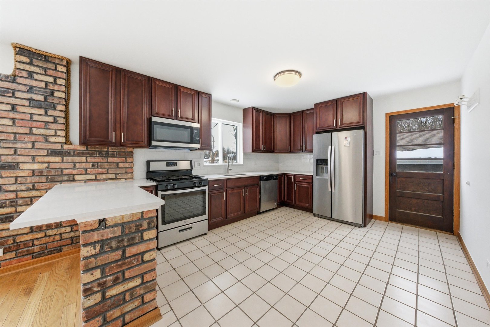 21122 Hillside Road Frankfort, IL 60423 - Photo 16 of 48 a kitchen with granite countertop a refrigerator and a stove top oven