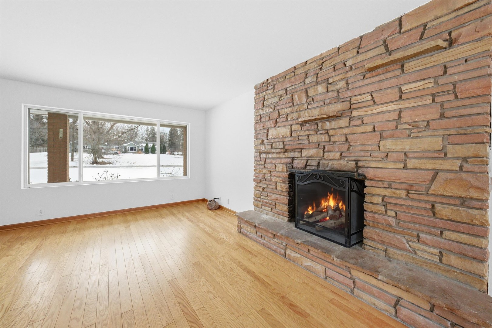 21122 Hillside Road Frankfort, IL 60423 - Photo 6 of 48 a view of an empty room with wooden floor fire place and windows