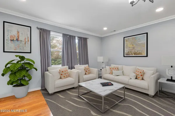 a living room with furniture or couch and a potted plant