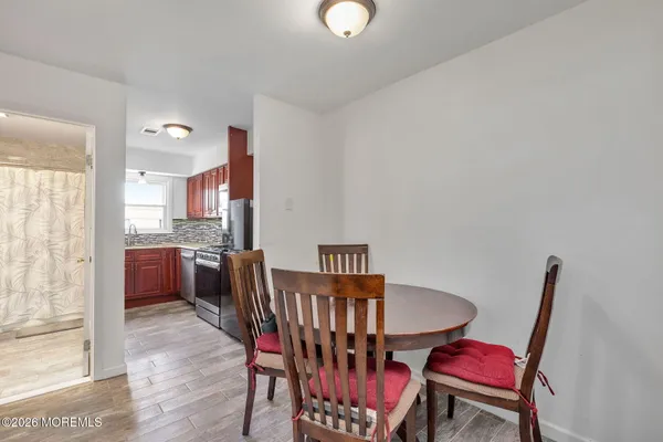 a view of a dining room with furniture and wooden floor