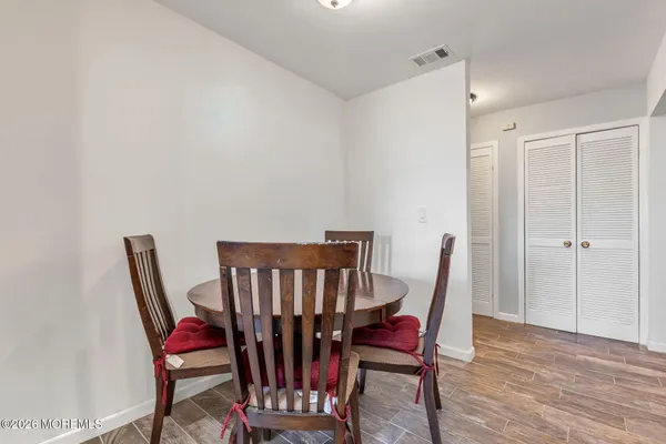 a view of a dining room with furniture and wooden floor