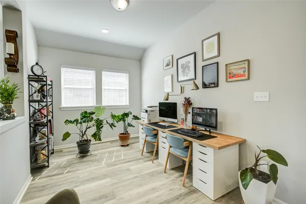 a workspace with furniture and a potted plant