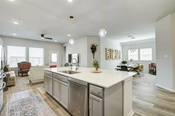 a kitchen with a sink and wooden floor