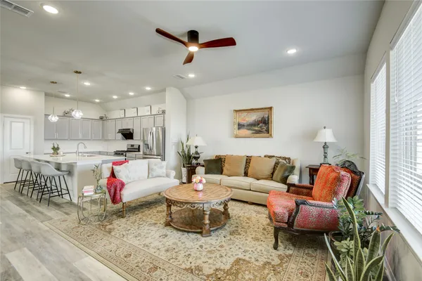 a living room with furniture and kitchen view