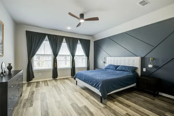 a bedroom with a large bed and a large window