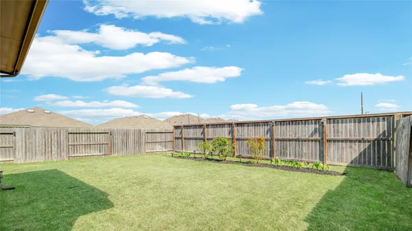 a view of a backyard with a garden and deck