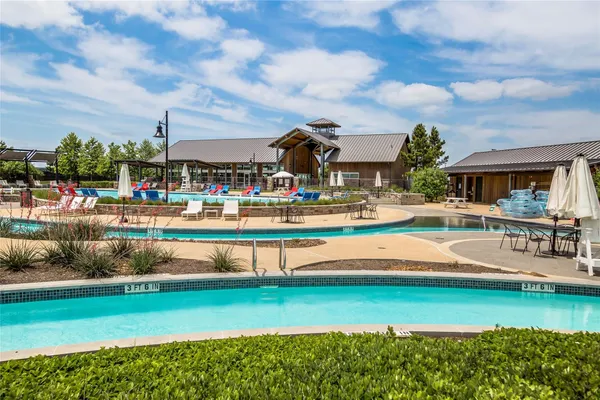 a view of swimming pool with outdoor seating