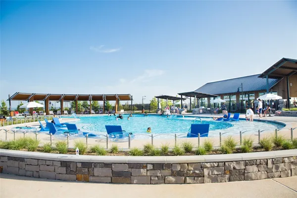 a view of swimming pool with outdoor seating
