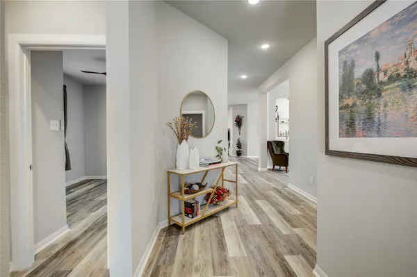 a view of a bedroom with a bed and wooden floor