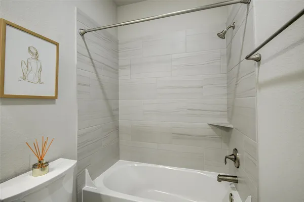 a bathroom with a bathtub and a shower