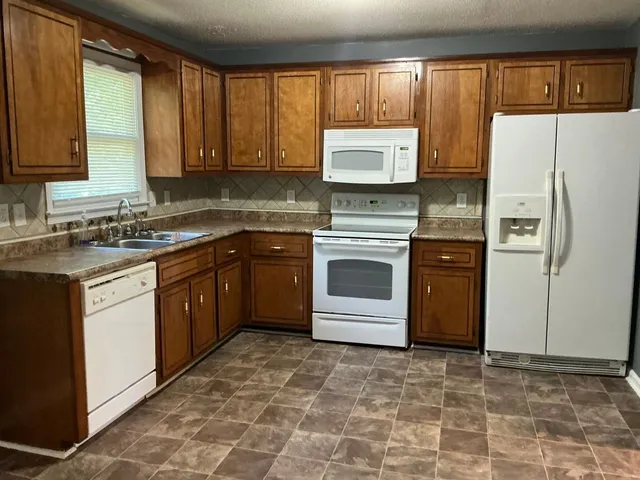 a kitchen with a sink stove and refrigerator