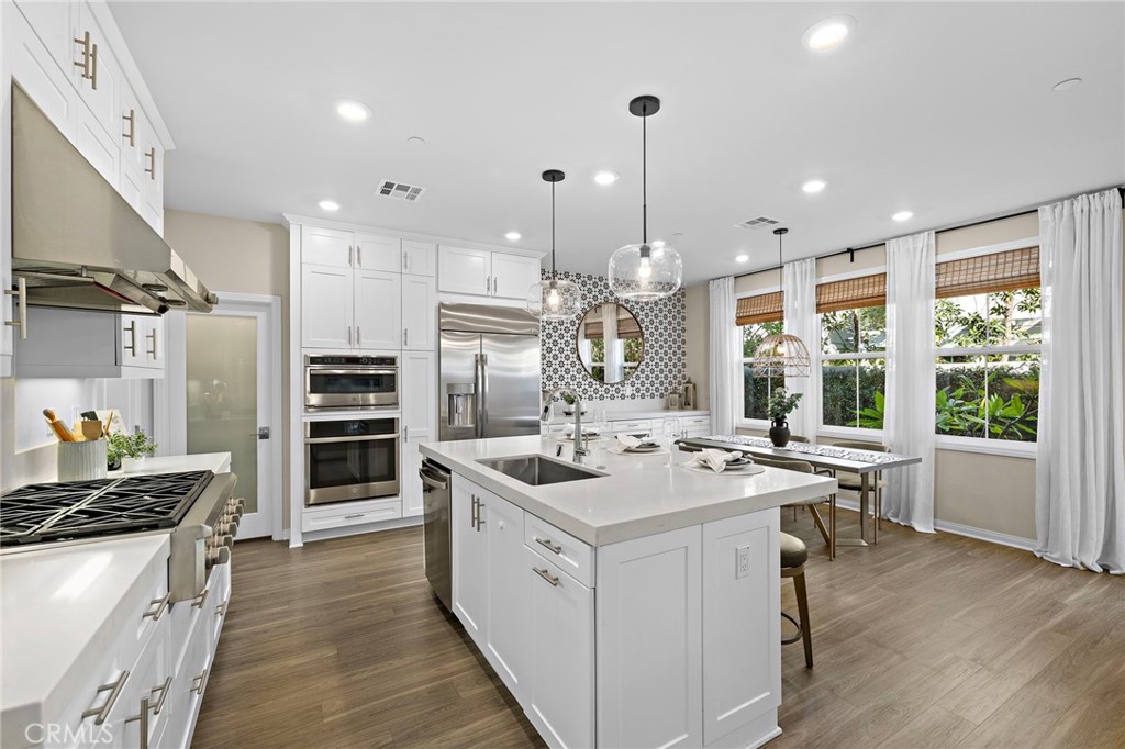 26 Paranza Place Rancho Mission Viejo, CA 92694 - Photo 1 of 65 a kitchen that has a lot of cabinets in it