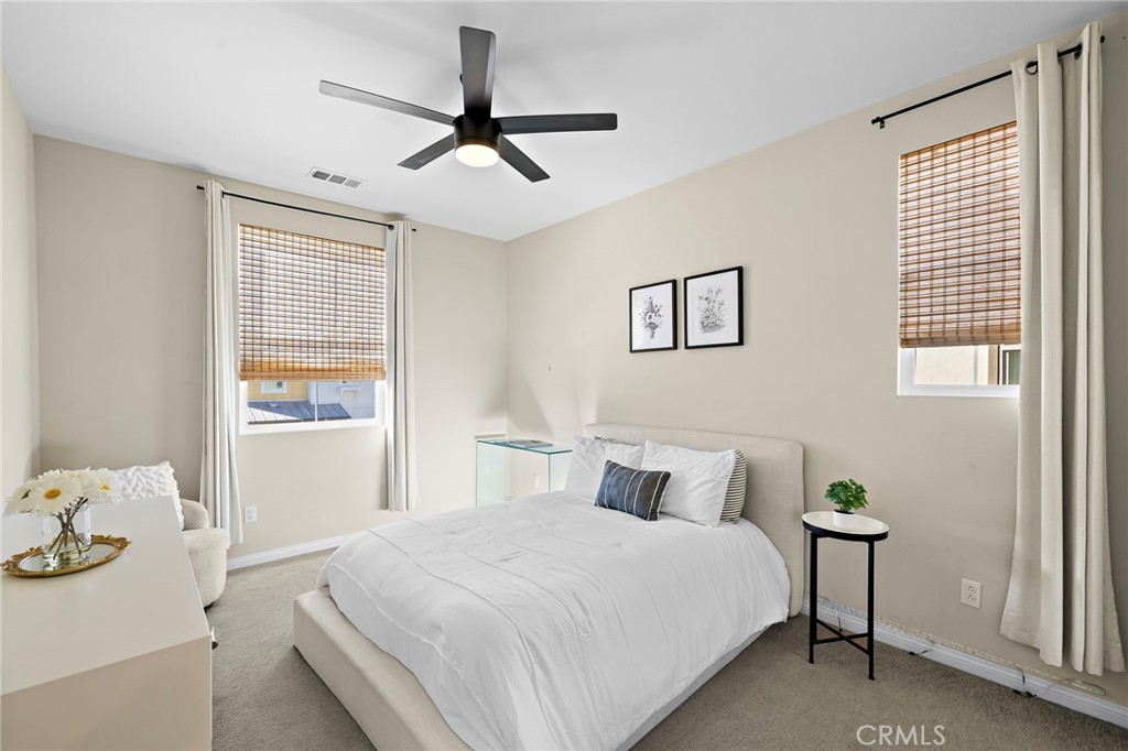 26 Paranza Place Rancho Mission Viejo, CA 92694 - Photo 19 of 65 a bedroom with a bed and a chandelier