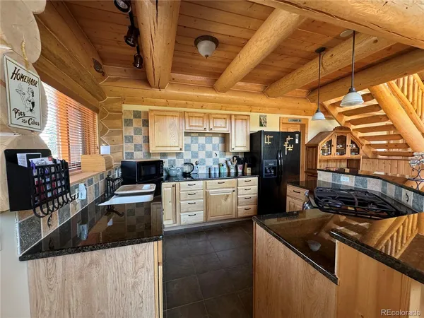 a kitchen with stainless steel appliances granite countertop a sink and wooden cabinets