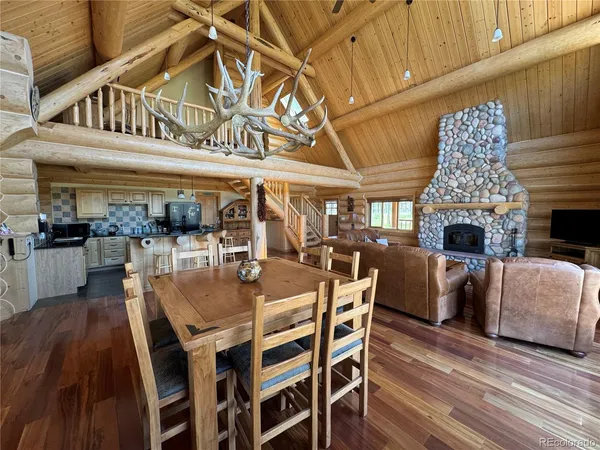 a view of a dining room with furniture wooden floor and chandelier