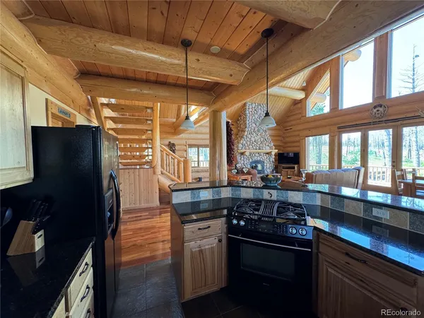 a kitchen with stainless steel appliances granite countertop a sink and a stove