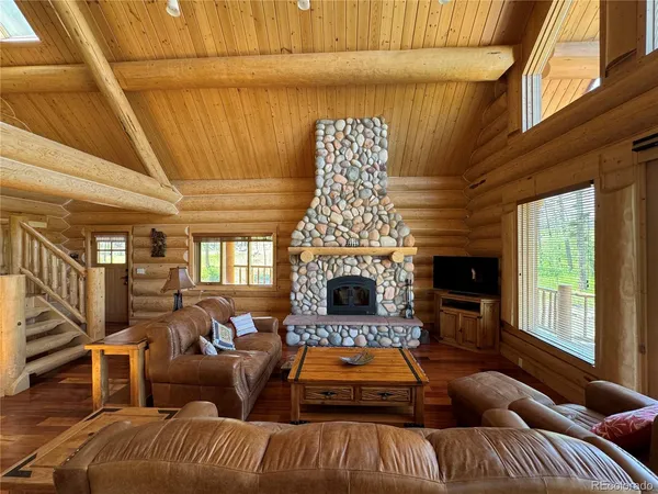 a living room with furniture fireplace and flat screen tv