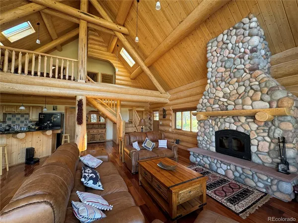 a living room with furniture a fireplace and a table