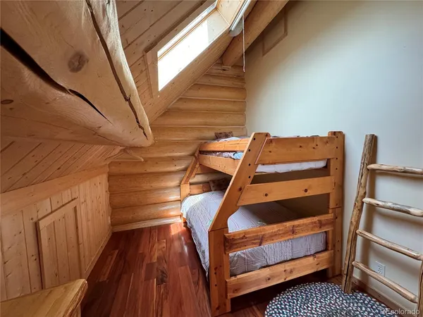 a view of room with stairs and wooden floor