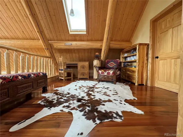 a bedroom with a bed with wooden floor