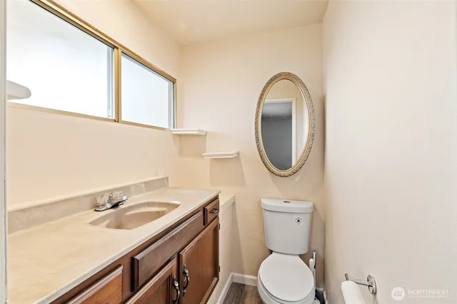a bathroom with a toilet sink and mirror