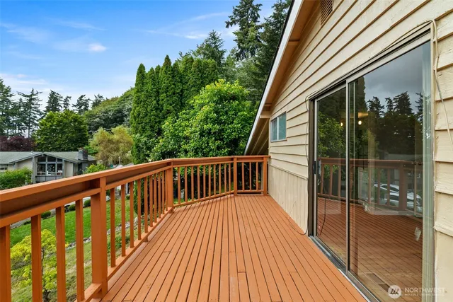 a balcony with wooden floor and fence