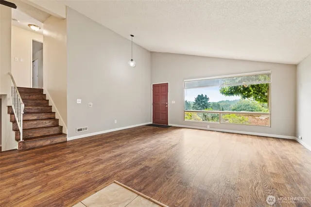 wooden floor in an empty room with a window