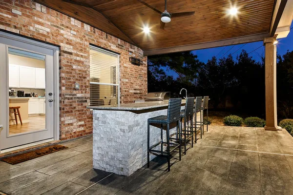 a kitchen with stainless steel appliances granite countertop a sink a stove and a refrigerator