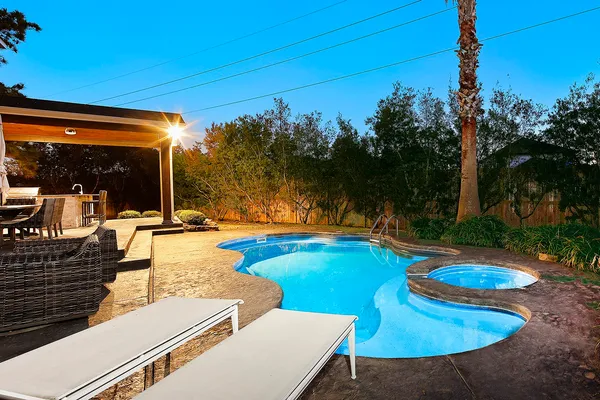 an aerial view of house with yard swimming pool and outdoor seating