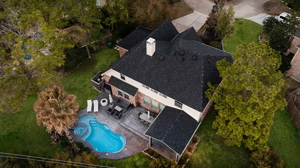 an aerial view of a house with a yard