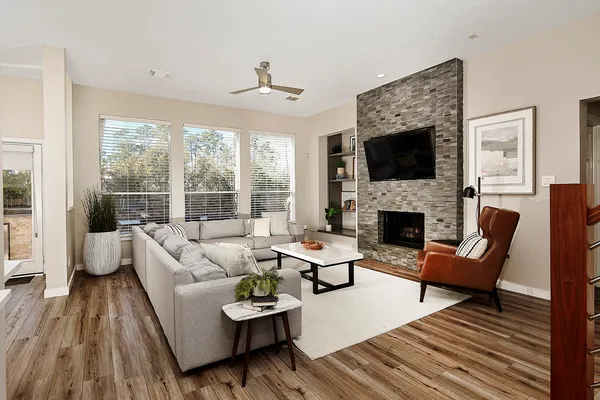 a living room with furniture and a potted plant